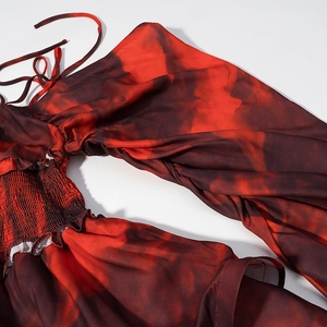 Detail of red floral smocking and adjustable spaghetti straps on the summer mini dress