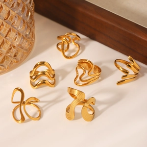 Exaggerated 18K gold plated stainless steel irregular rings set on a white surface