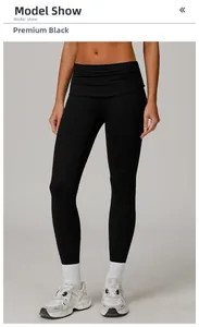 Detailed view of high-waist yoga leggings in premium black with folded waistband