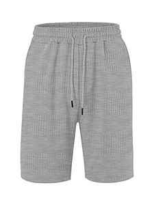Close-up of gray waffle texture fabric on men's casual shorts with drawstring