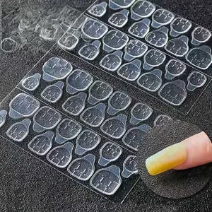 Detailed macro view of 24 pieces clear high adhesive jelly glue tabs for press-on nails