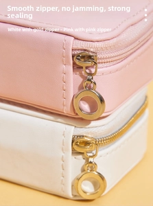 Close-up of smooth metal zippers and PU leather texture on portable jewelry boxes