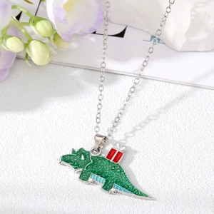 Detail of green glitter dinosaur pendant with gift box on silver necklace chain