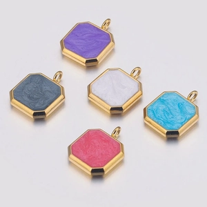 Macro shot of colorful octagonal enamel charms with gold edges for jewelry making