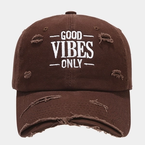 Detailed view of the Good Vibes Only embroidery and distressed brim on the brown cap