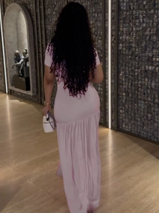 Pink short sleeve maxi dress with pleated details and side slit shown from the back