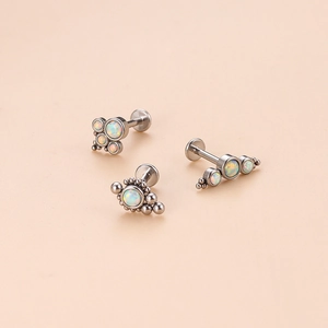 Three-piece set of stainless steel lip studs featuring white opal in cluster and arc designs