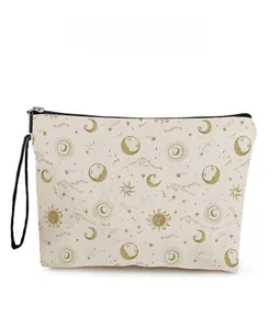 Detail of canvas makeup bag with sun and moon gold patterns and black zipper