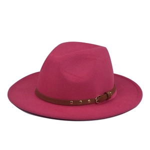 Close-up of fuchsia wool fedora hat with brown studded faux leather strap and metal buckle