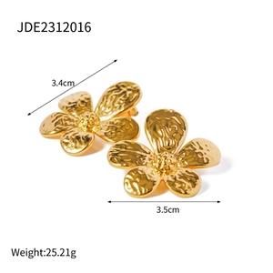 Detail view of 18k gold plated hammered metal flower earrings with dimensions 3.4cm by 3.5cm