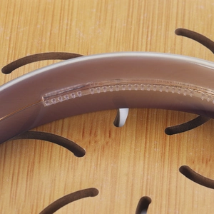 Macro shot of non-slip inner teeth on brown acetate headband for secure grip