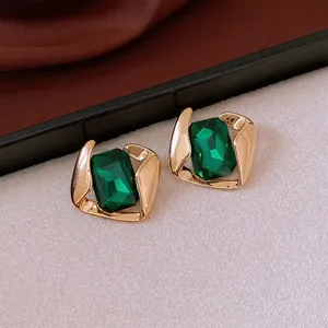 Vintage gold-tone stainless steel stud earrings with rectangular emerald green stones
