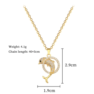 Detail view of a gold dolphin necklace with crystal inlay and precise measurements