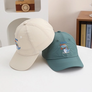 Detail of children's baseball cap with breathable side vents and dinosaur embroidery