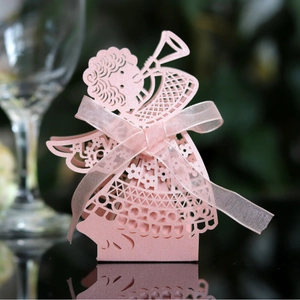 Pink laser-cut girl-shaped candy box with floral patterns and a ribbon bow
