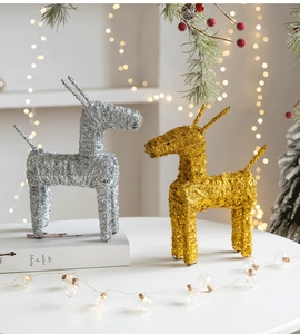 Detail of glittered iron Christmas reindeer statues in gold and silver for festive decor