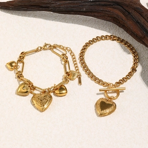 Gold stainless steel Cuban chain bracelet with heart pendants and OT clasp on stone