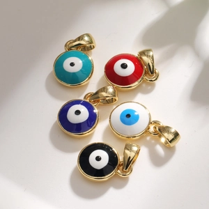 Detail of five gold-plated enamel evil eye pendants in blue, red, black, and white colors