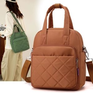 Close-up of brown quilted nylon tote bag with adjustable strap and top handle design