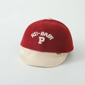Detail of red and cream corduroy baby cap with Hi-Baby P embroidery and fabric texture