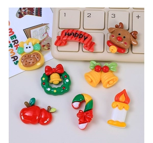 Flat lay of Christmas DIY resin charms including Santa, bells and candy canes for crafts