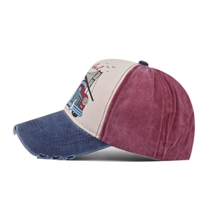 Detail of vintage patchwork baseball cap with distressed denim brim and retro graphic print