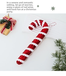 Close-up of a red and white glittery Christmas candy cane ornament with a fluffy white spiral