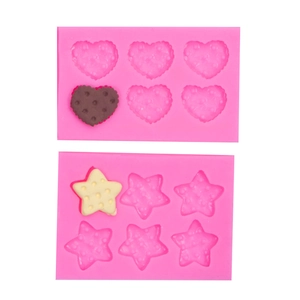 Pink silicone fondant molds in heart and star shapes for DIY cake and cookie decorating