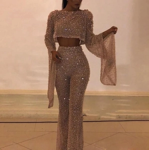Detail of champagne gold sequin two-piece set with long sleeve crop top and wide leg pants