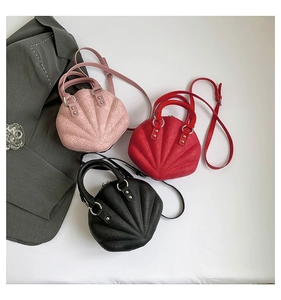 Three shell bags in pink, red, and black with floral embossing on a grey blazer