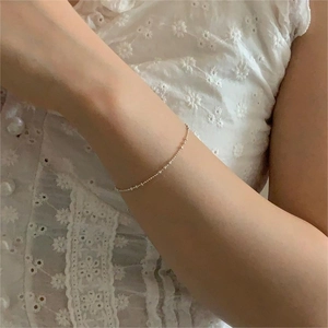 Minimalist 925 sterling silver beaded bracelet for women worn on wrist with lace sleeve