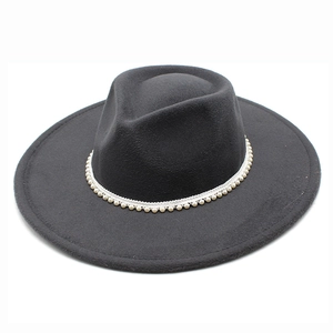 Close-up of elegant black wool fedora featuring white pearl trim around the wide brim