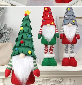 Close-up of three festive Christmas gnomes in red green and grey for home decoration