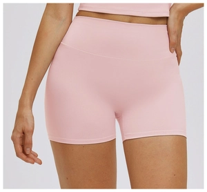 Close-up detail of high-waisted pink yoga shorts featuring seamless stitching and elastic fabric