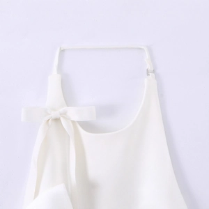 White halter top with silk satin bow tie and adjustable silver buckle on a clean background