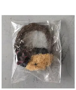 Detail view of Halloween wreath with black roses and spider in clear packaging