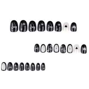 Gothic Y2K short almond press-on nails featuring black bows and heart star patterns