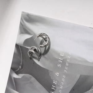 Polished silver stainless steel multi-layered twisted hoop earrings with a spiral design