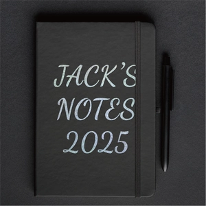 Macro shot of 2025 black planner with silver glitter lettering and elastic band closure