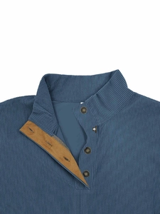 Detailed close-up of blue corduroy pullover featuring a metal snap button and contrast lining