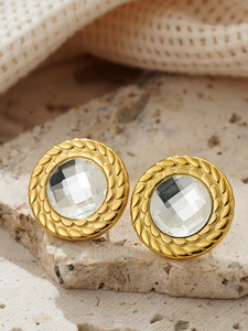 Macro view of vintage 18K gold plated round stud earring with central faceted crystal