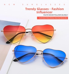 Flat lay of vintage heart shaped sunglasses with colorful gradient lenses and gold frames
