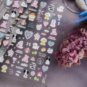 Macro detail of 3D embossed nail stickers featuring colorful cartoon dogs and hearts