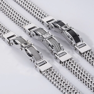 Detail of silver stainless steel bracelets with carbon fiber and steel cable inlays