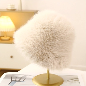 Plush faux fur Mongolian hat in cream white displayed on a stylish metal stand
