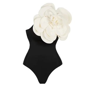 Detail of 3D white camellia flower ornament on black one-piece swimsuit shoulder