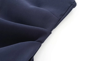 Macro detail of dark blue fabric texture and precise stitching on the strapless top