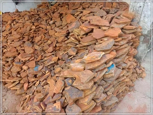 Close-up of raw natural chakra crystal stones in irregular flat shapes and earthy tones