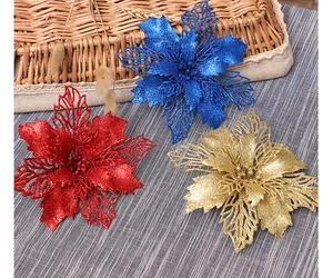 Detail of glittered hollow mesh Christmas flowers in red, blue and gold colors