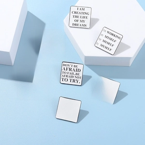 Detailed view of white square enamel pins with black motivational quotes on blue background